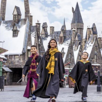 Kids in Hogwarts robes walking through Hogsmeade at Universal Orlando