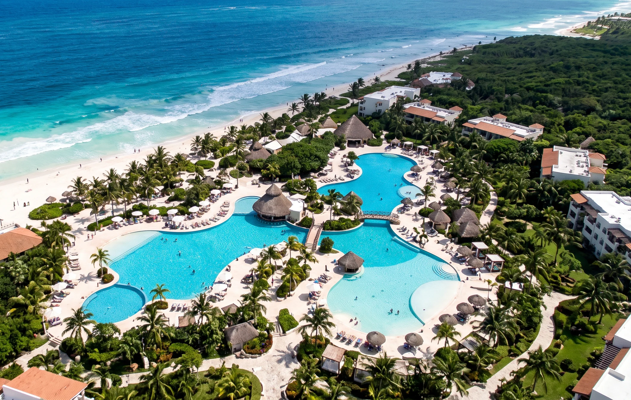 Mexico Resort Aerial view of a Mexico beach resort with lagoon-style pools and thatched huts