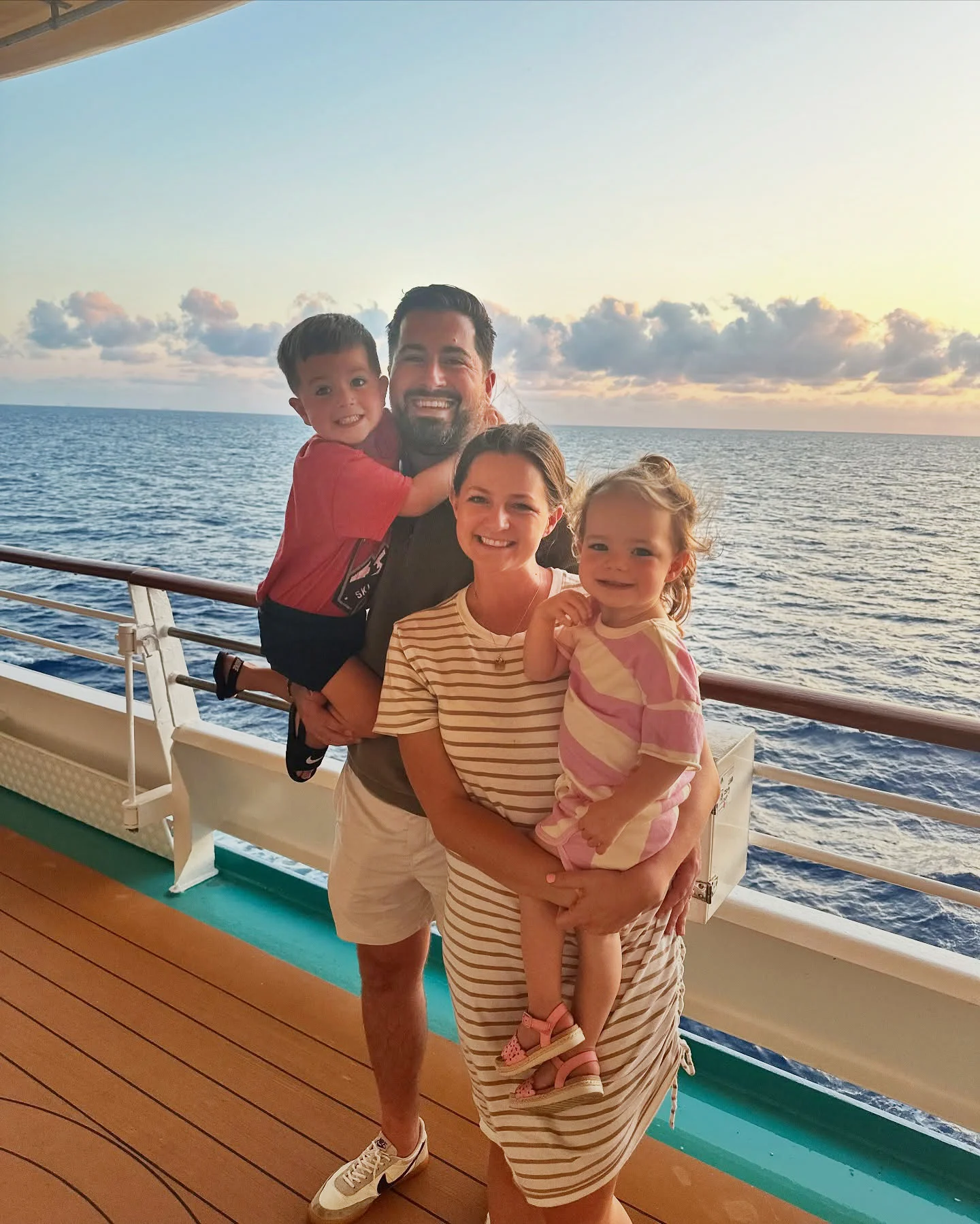 485028069 18296122642240731 6595294300395480193 N Family of four smiling together on a cruise ship deck at sunset